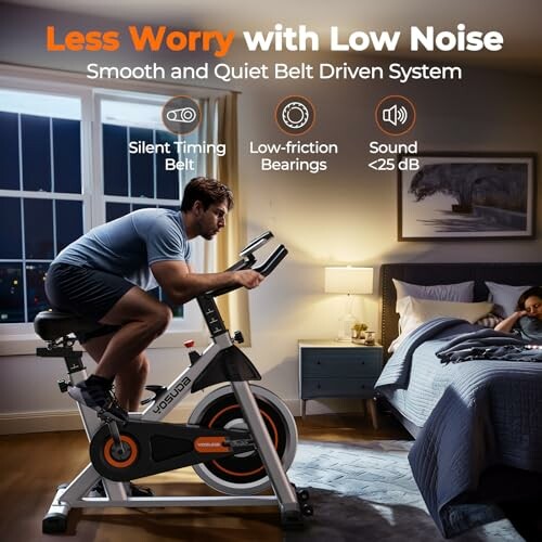 Man using a quiet exercise bike in a bedroom while child sleeps.