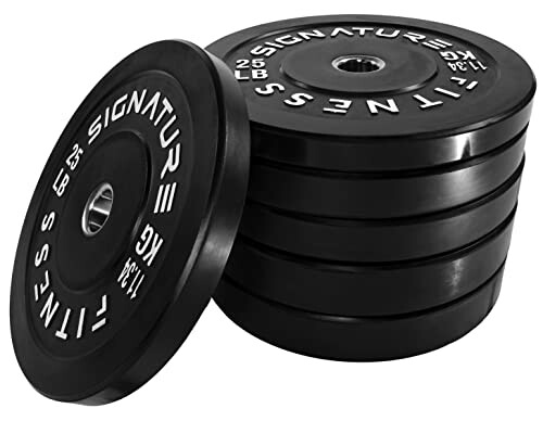 Stack of black weight plates with white lettering.